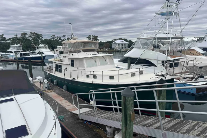 Slide: The Image of 1998 Krogen Express 49 yacht on dry dock under clear blue sky. - 88