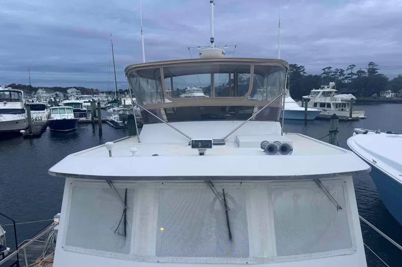 Slide: The Image of 1998 Krogen Express 49 yacht docked beside another boat in a marina. - 12