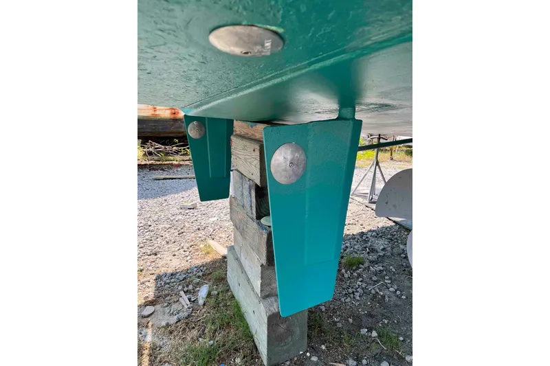 Slide: The Image of 1998 Krogen Express 49 yacht docked at marina, side view with railing and mooring lines. - 17