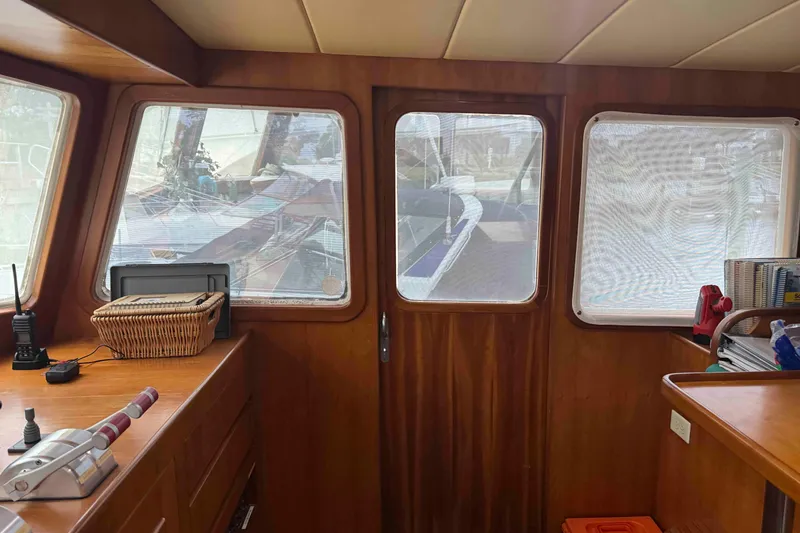 Slide: The Image of Interior of 1998 Krogen Express 49 with red and blue chairs, nautical decor. - 29