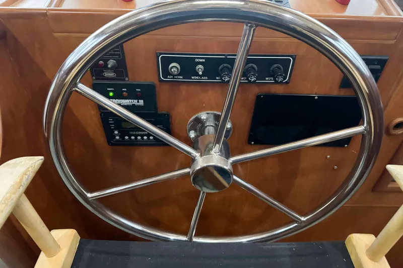 Slide: The Image of Cozy interior of 1998 Krogen Express 49 with white seating and wooden table. - 30