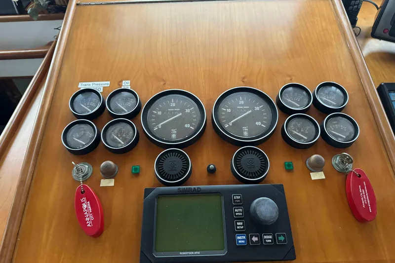 Slide: The Image of Compact kitchen in a 1998 Krogen Express 49 boat with appliances and wooden accents. - 32