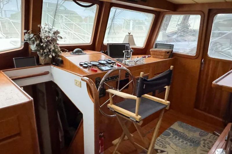 Slide: The Image of Interior of 1998 Krogen Express 49 yacht with wooden cabinetry and cozy seating area. - 33
