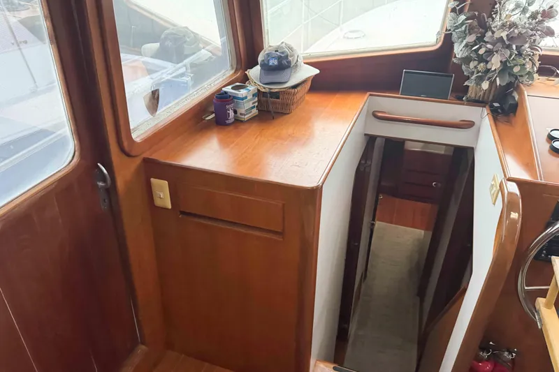 Slide: The Image of Electrical panel inside 1998 Krogen Express 49 yacht, featuring wooden cabinetry. - 34