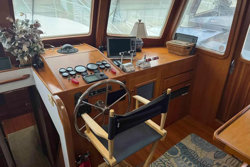 Slide: The Image of Cozy bedroom in 1998 Krogen Express 49 yacht with elegant wood finish and decorative pillows. - 35