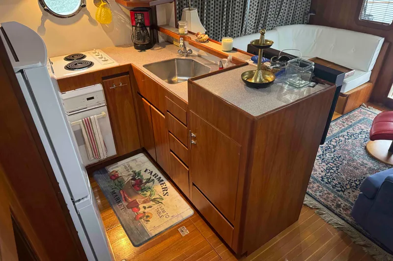 Slide: The Image of Wooden drawers under bed on 1998 Krogen Express 49 yacht, with white bedding. - 39