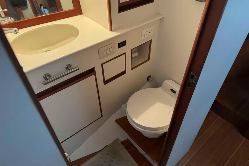 Slide: The Image of Wooden interior of 1998 Krogen Express 49 yacht cabin with bed and storage. - 53