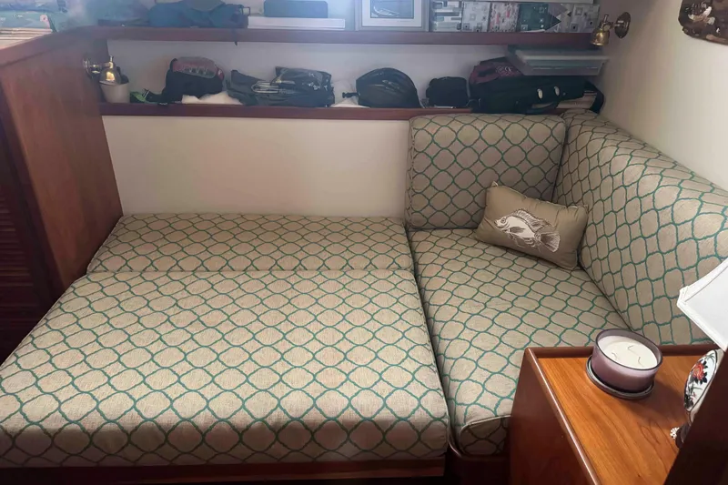 Slide: The Image of Engine room of 1998 Krogen Express 49 with yellow marine engine and maintenance tools. - 57