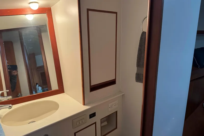 Slide: The Image of Engine room of a 1998 Krogen Express 49 yacht, showcasing dual engines and mechanical components. - 58