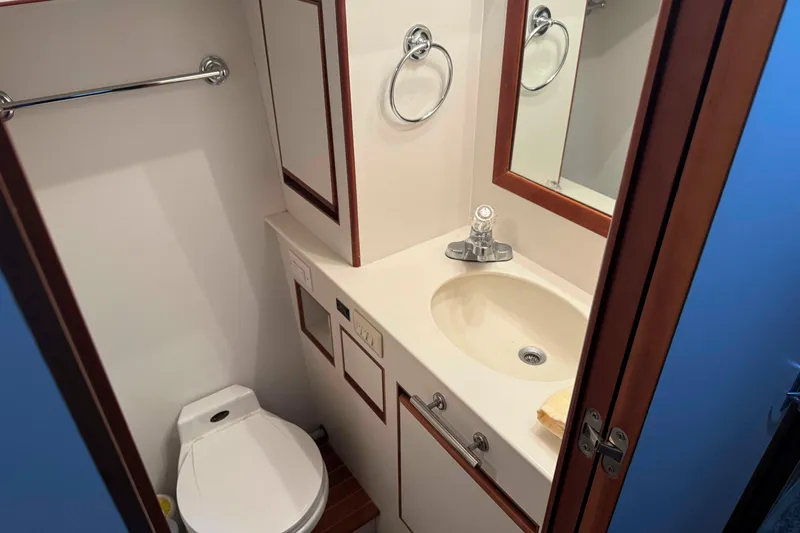 Slide: The Image of Engine room of a 1998 Krogen Express 49 yacht, showcasing mechanical components and tools. - 59