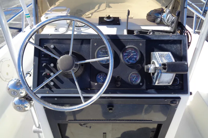 Slide: The Image of 1991 Wahoo 180 boat dashboard with steering wheel and gauges. - 10