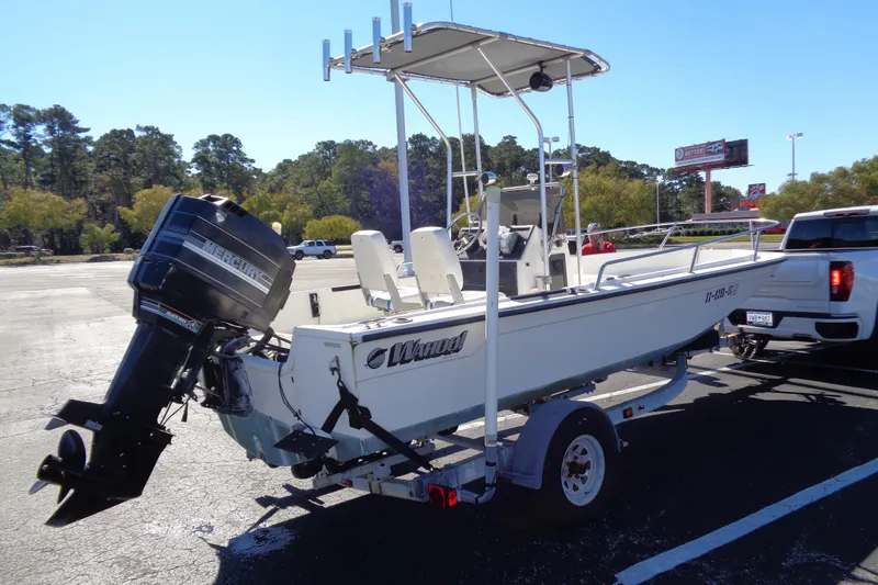 Slide: The Image of 1991 Wahoo 180 boat on trailer with Mercury outboard motor in parking lot. - 12