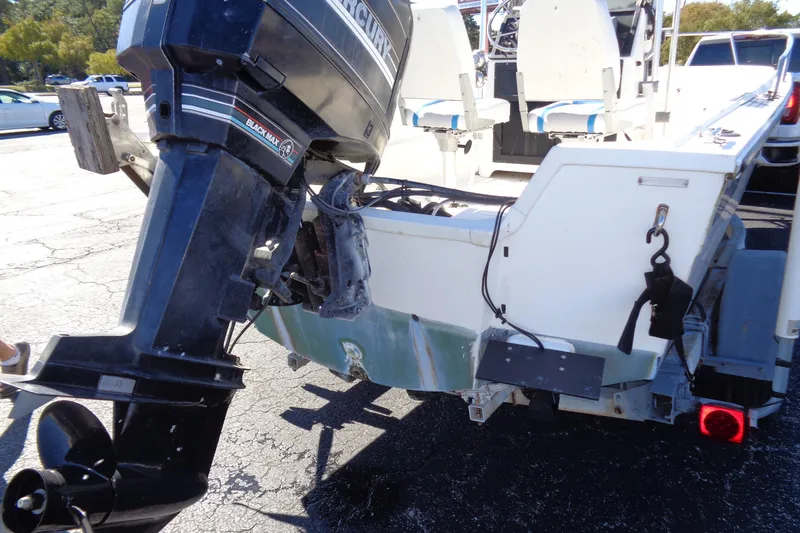 Slide: The Image of 1991 Wahoo 180 boat with Mercury Black Max outboard motor, parked on a trailer. - 13