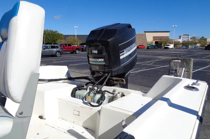Slide: The Image of 1991 Wahoo 180 boat with Mercury 150 outboard motor in parking lot. - 3