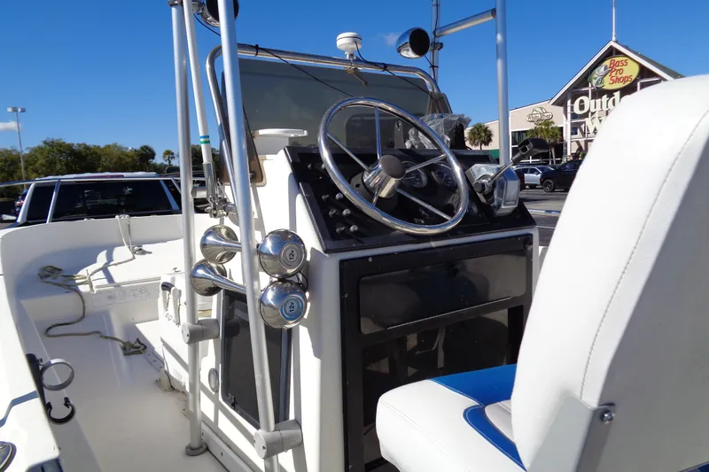 Slide: The Image of 1991 Wahoo 180 boat interior with steering wheel, parked near Bass Pro Shops. - 4