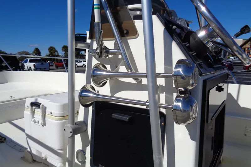 Slide: The Image of 1991 Wahoo 180 boat console with chrome horns and steering wheel in a parking lot. - 5
