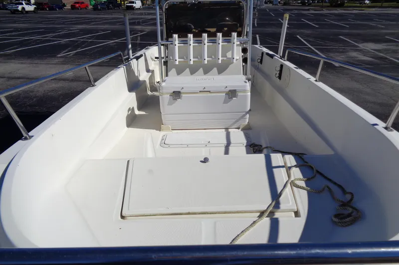 Slide: The Image of 1991 Wahoo 180 boat interior with seating and storage, parked in a lot. - 6