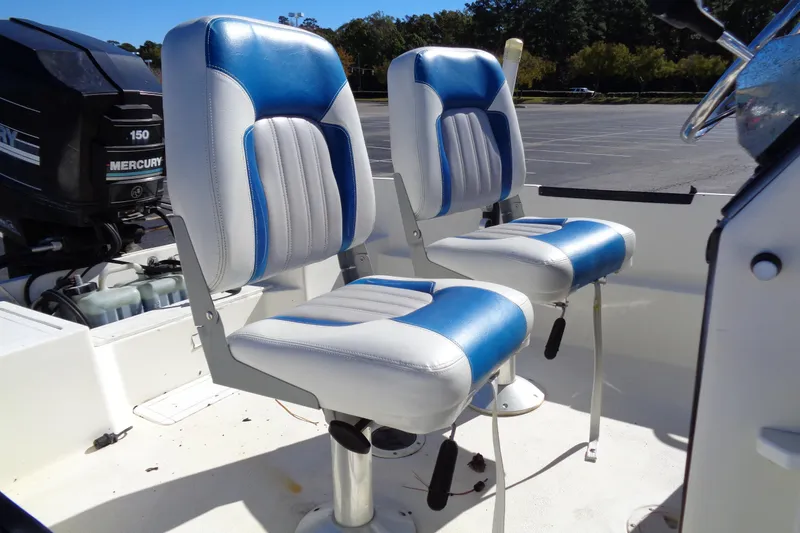 Slide: The Image of 1991 Wahoo 180 boat with blue and white seats, Mercury 150 engine visible. - 8