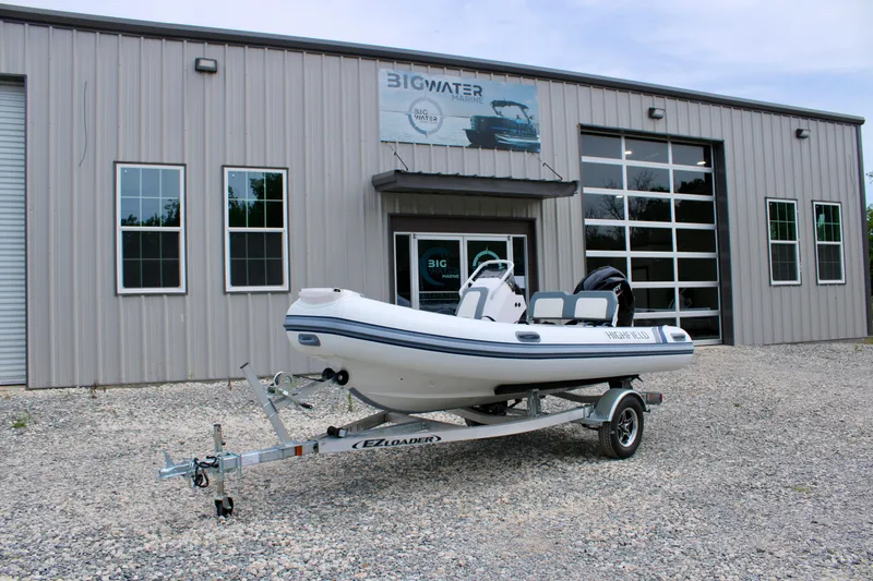 Slide: The Image of 2023 Highfield CL420 boat on trailer outside Big Water Marine building. - 8