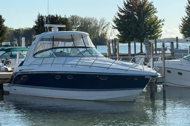 The Image of 2005 Formula 37 Performance Cruiser docked at marina, surrounded by trees and calm water. - 0