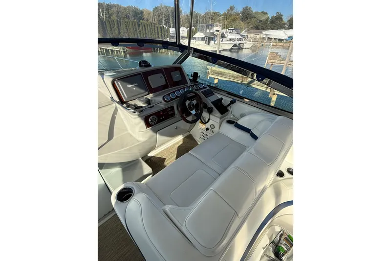 Slide: The Image of 2005 Formula 37 Performance Cruiser cockpit with white seating and modern dashboard controls. - 16