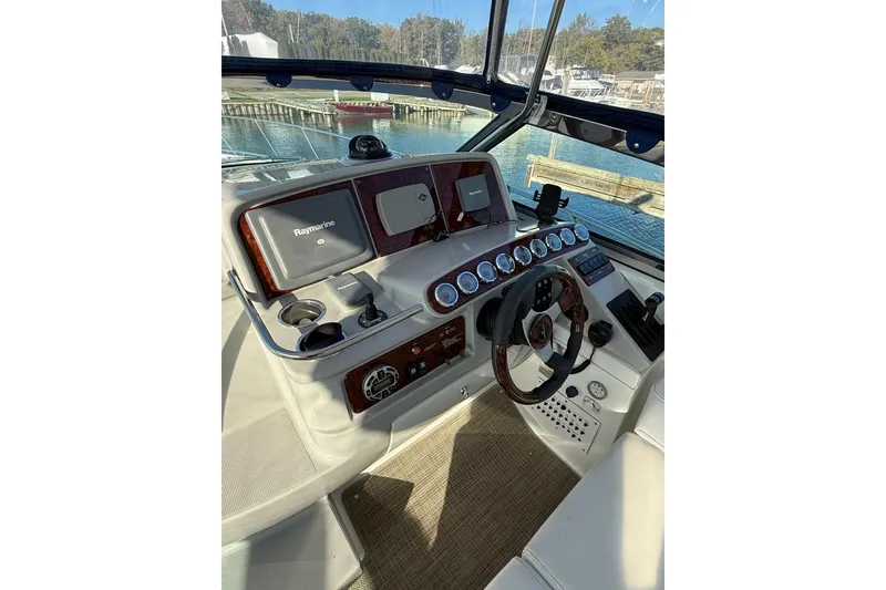 Slide: The Image of 2005 Formula 37 Performance Cruiser helm with Raymarine electronics and wood-accented steering wheel. - 17