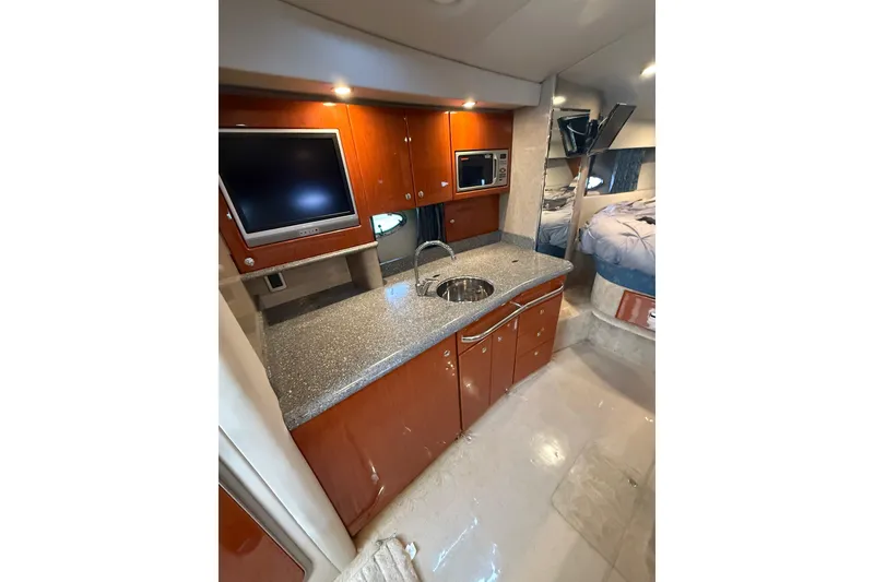 Slide: The Image of 2005 Formula 37 Performance Cruiser interior with kitchenette, TV, and bed. - 23