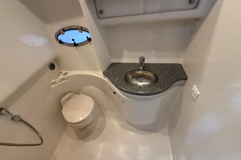 Slide: The Image of 2005 Formula 37 Performance Cruiser bathroom with sink, toilet, and porthole window. - 25