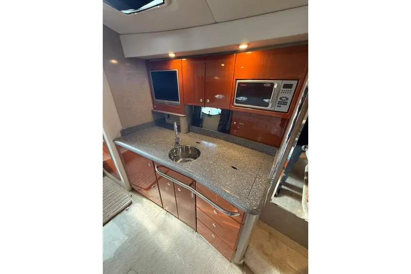Slide: The Image of 2005 Formula 37 Performance Cruiser kitchen with sleek countertop, sink, and built-in microwave. - 27