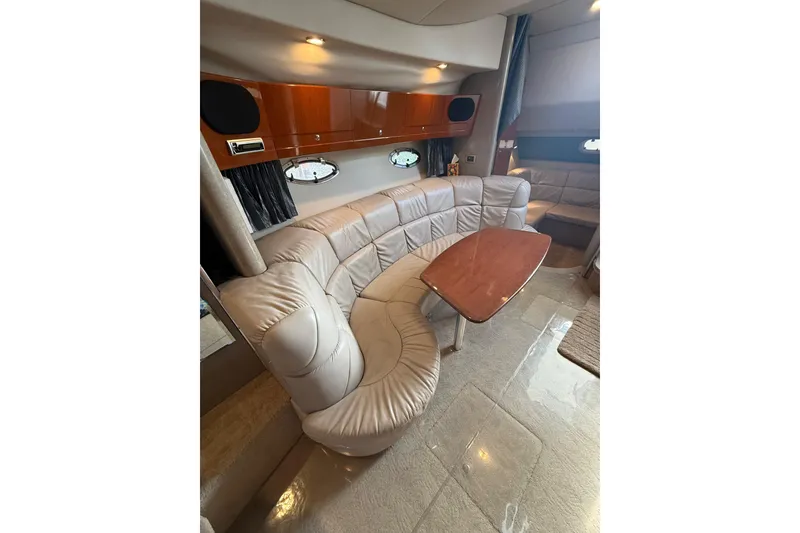 Slide: The Image of Luxurious interior of a 2005 Formula 37 Performance Cruiser with plush seating and wooden table. - 28
