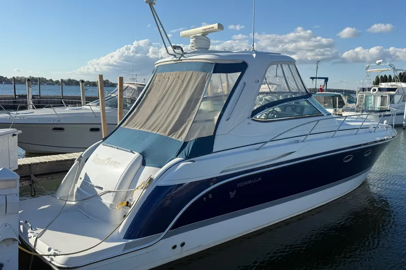 Slide: The Image of 2005 Formula 37 Performance Cruiser docked at marina under clear blue sky. - 3