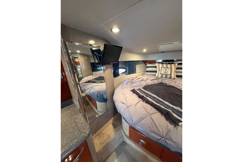 Slide: The Image of Interior of 2005 Formula 37 Performance Cruiser with cozy bed and nautical decor. - 37