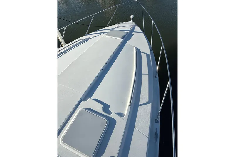 Slide: The Image of 2005 Formula 37 Performance Cruiser bow view on water, showcasing sleek design and railing. - 7