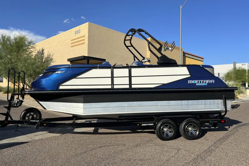 Slide: The Image of 2024 Montara 23 SURF BOSS 2.0 boat on trailer, parked outdoors. - 3