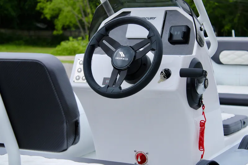 Slide: The Image of 2024 Highfield Sport 460 boat steering console with modern controls and sleek design. - 13