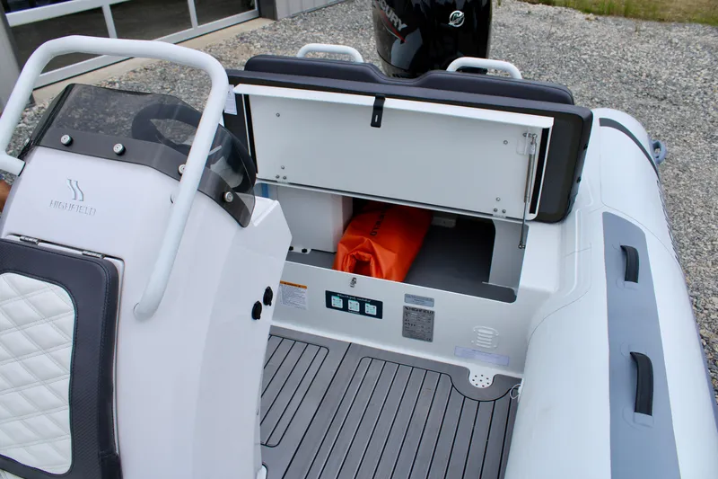 Slide: The Image of 2024 Highfield Sport 460 boat interior with storage compartment open, showcasing modern design. - 16