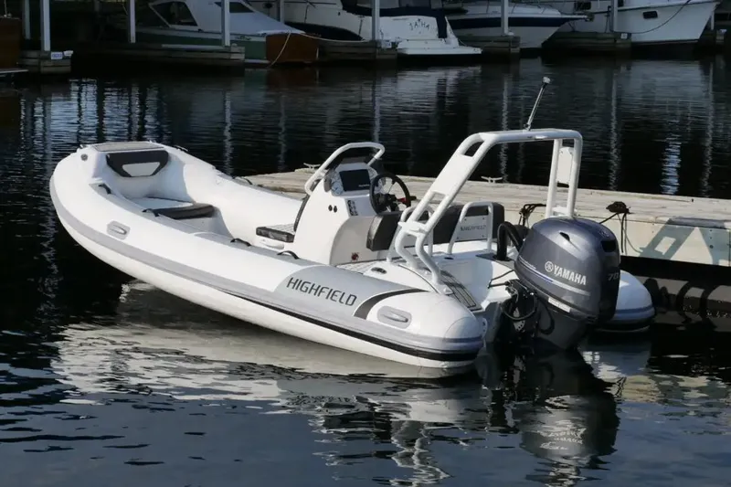 Slide: The Image of Manufacturer Provided Image: 2024 Highfield Sport 460 boat docked with Yamaha outboard motor. - 2