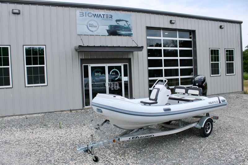 Slide: The Image of 2024 Highfield Sport 460 boat on trailer outside Big Water Marine building. - 6