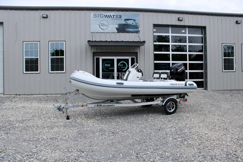 Slide: The Image of 2024 Highfield Sport 460 boat on trailer outside Big Water Marine building. - 8