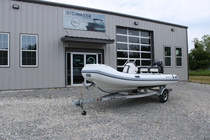 Slide: The Image of 2024 Highfield Sport 460 boat on trailer outside Big Water Marine building. - 9
