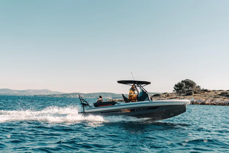 Slide: The Image of 2026 Highfield ADV 7 boat cruising on open water near rocky shoreline. - 3