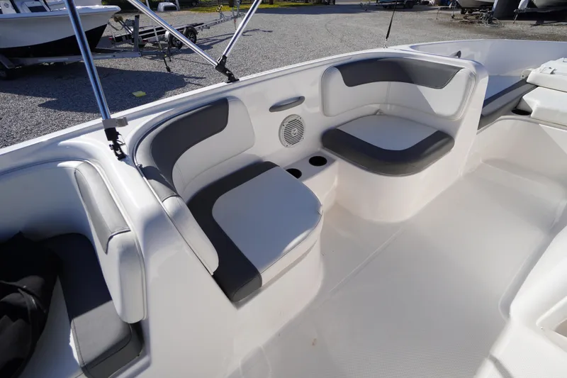 Slide: The Image of 2024 Bayliner Element E18 boat interior with cushioned seating and cup holders. - 11