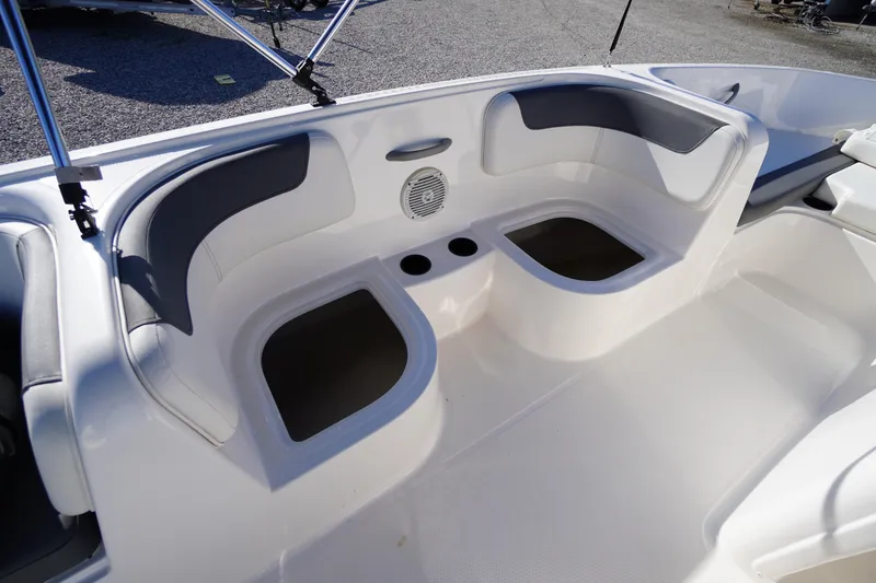 Slide: The Image of 2024 Bayliner Element E18 boat interior with cushioned seating and storage compartments. - 12