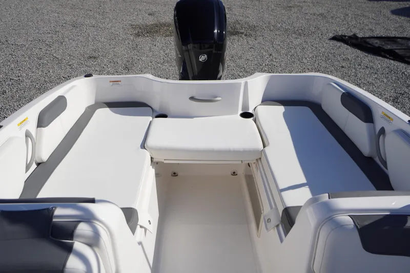 Slide: The Image of 2024 Bayliner Element E18 boat interior with white seating and outboard motor. - 14