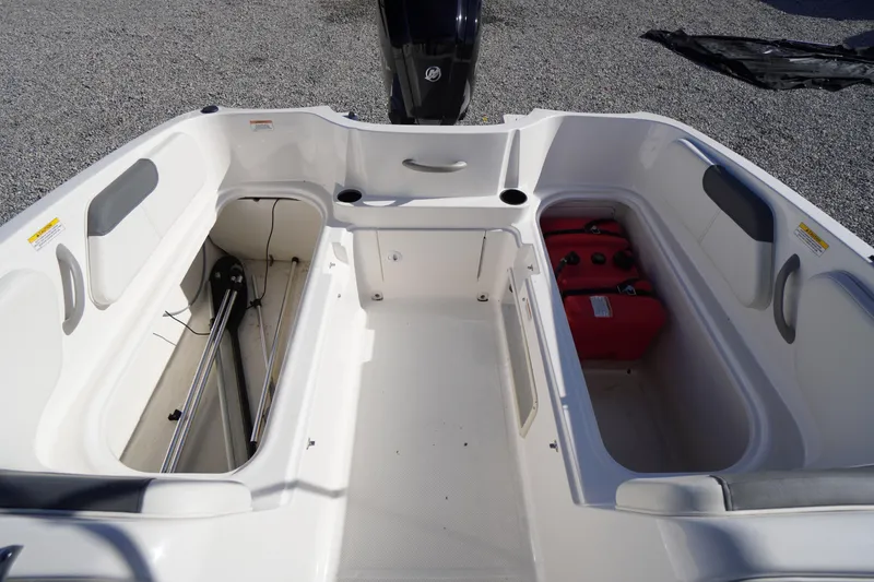 Slide: The Image of 2024 Bayliner Element E18 boat interior with storage compartments and seating. - 16