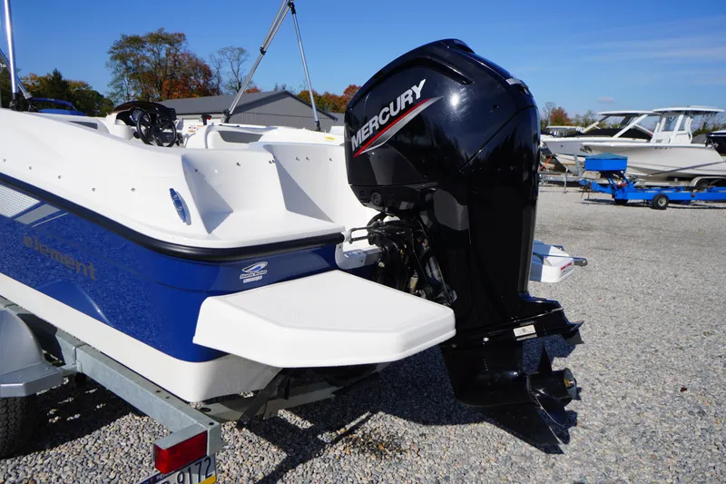 Slide: The Image of 2024 Bayliner Element E18 boat with Mercury outboard motor on a trailer. - 21