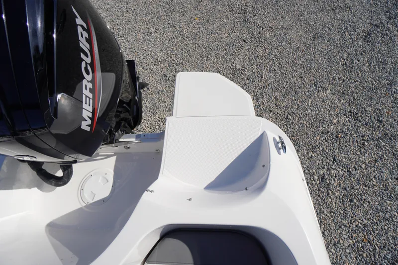 Slide: The Image of 2024 Bayliner Element E18 boat with Mercury engine on gravel surface. - 23