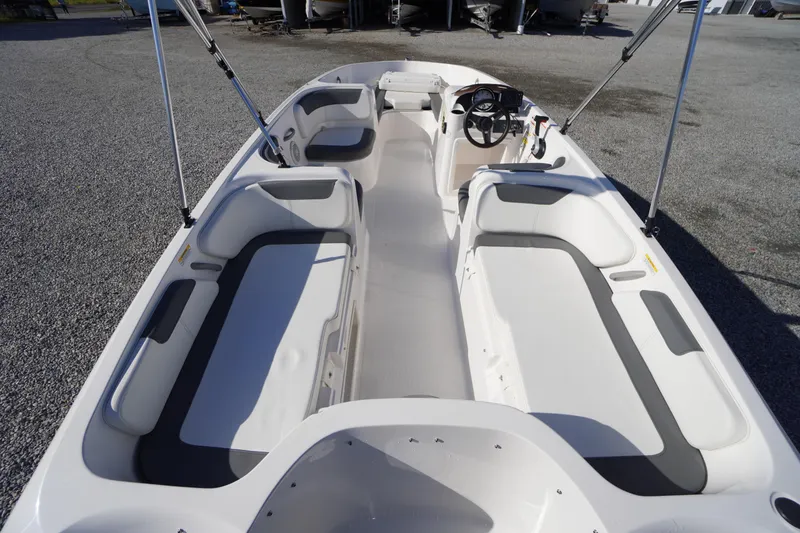 Slide: The Image of 2024 Bayliner Element E18 boat interior with spacious seating and steering console. - 3