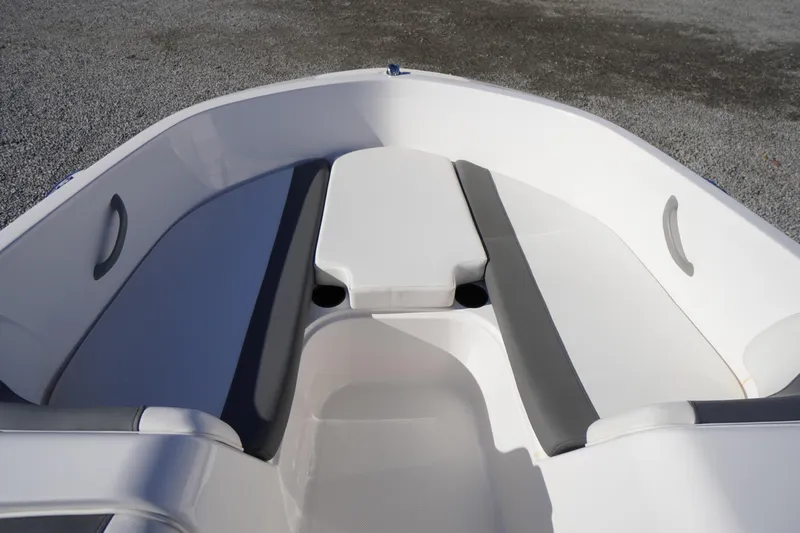 Slide: The Image of 2024 Bayliner Element E18 boat interior with gray seating and white deck. - 4