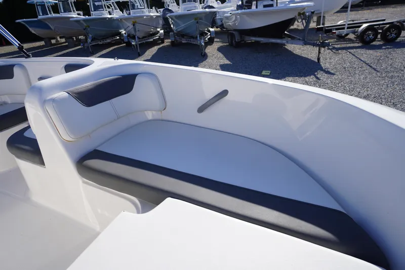 Slide: The Image of 2024 Bayliner Element E18 boat interior seating with sleek design and comfortable cushions. - 5